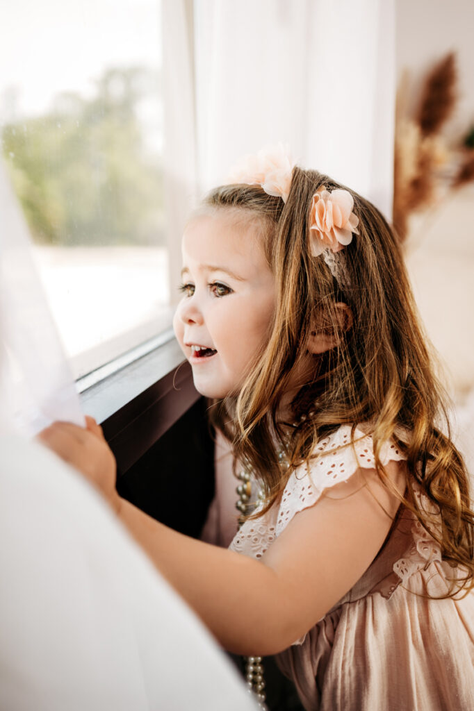 Family Photography, Little girl looking out of an open window