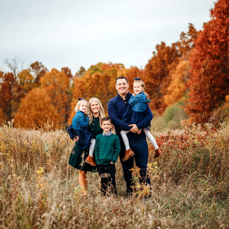 Family Photography, family of 5 standing in a field with tall grass, all looking at the camera